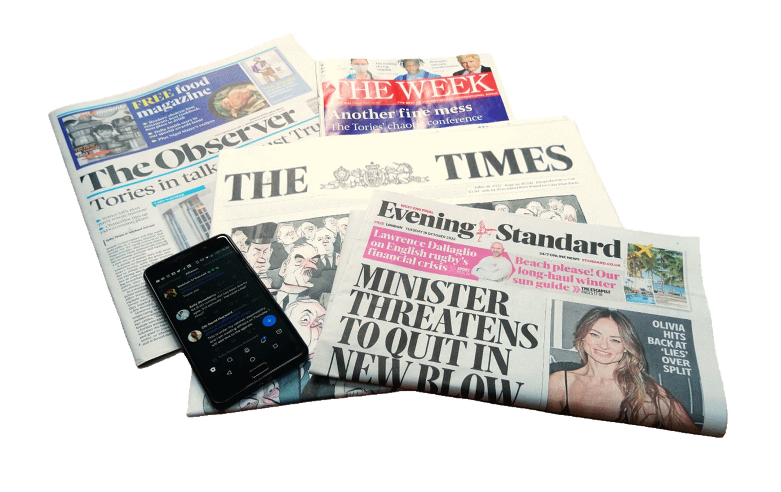 Photograph of several newspapers and a mobile phone